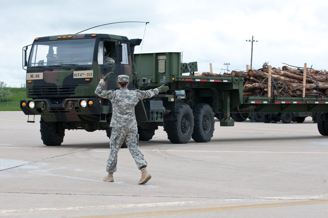 U.S. Army Spc. Erica Gardenas, motor transport operator assigned to the 1074th Transportation Company, Broken Bow, Neb., marshals a vehicle during Golden Coyote activities at Ellsworth Air Force Base, S.D., June 12, 2013. Golden Coyote is a three-phase, annual, joint training exercise conducted every June in which units perform a vast array of tasks and drills. (U.S. Air Force photo by Airman 1st Class Alystria Maurer/Released)