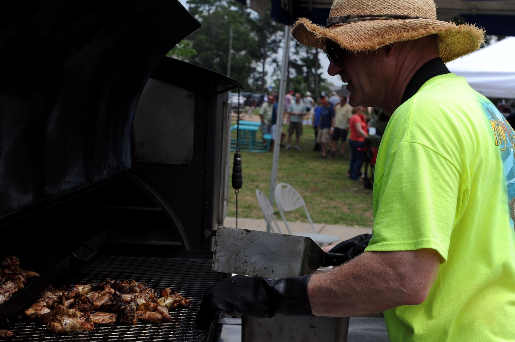 Jim Cosson, Full Steam Ahead BBQ owner, barbeques chicken for the Air Force Special Operations Command picnic at Hurlburt Field, Fla. June 14, 2013. More than 900 Airmen and family members attended the picnic. (U.S. Air Force photo/Staff Sgt. Eboni Reams)