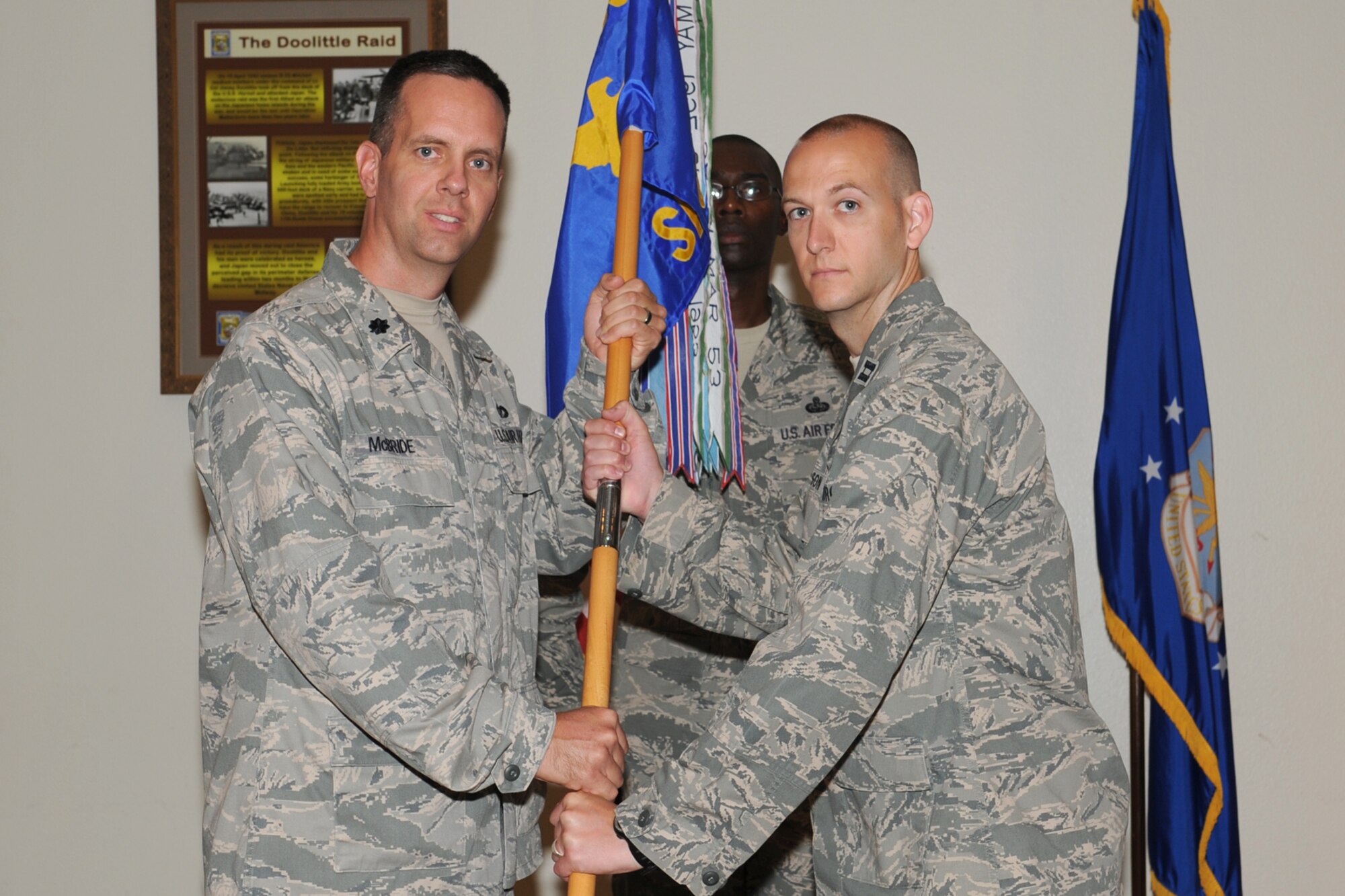 GOODFELLOW AIR FORCE BASE, Texas -- Lt. Col. Jeffrey McBride, 17th Mission Support Group Commander, passes the 17th Security Forces Squadron guidon to the incoming commander, Capt. James Nelson, during the Change of Command ceremony, May 29. The change of command ceremony is steeped in tradition and allows units to witness the formal command transfer from one officer to another. (U.S. Air Force photo by Staff Sgt. Laura R. McFarlane)
