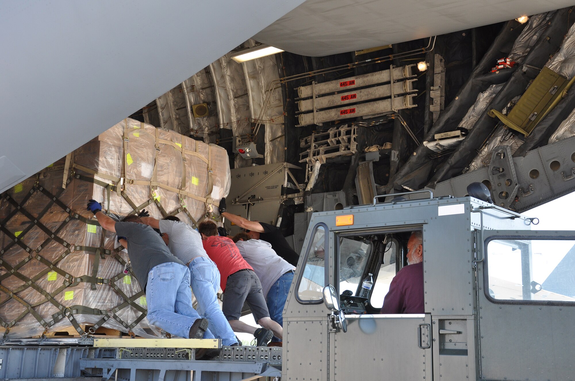 WRIGHT-PATTERSON AIR FORCE BASE, Ohio – Ten pallets containing approximately 90,000 pounds of dried and sealed food packets, the equivalent of 541,728 meals, are loaded onto a  445th Airlift Wing C-17 Globemaster III June 14 for delivery to Haiti. The food, provided by Kids Against Hunger, a ministry of A Child’s Hope International from Cincinnati, is being transported to Haiti as part of the Denton Program. The Denton Program is administered by the U.S. Agency for International Development, Department of State and Department of Defense. This allows U.S. based non-governmental sources to transport humanitarian aid at little or no cost to the donor, while simultaneously putting the extra space on U.S. military transport assets to good use. (U.S. Air Force photo/Stacy Vaughn)