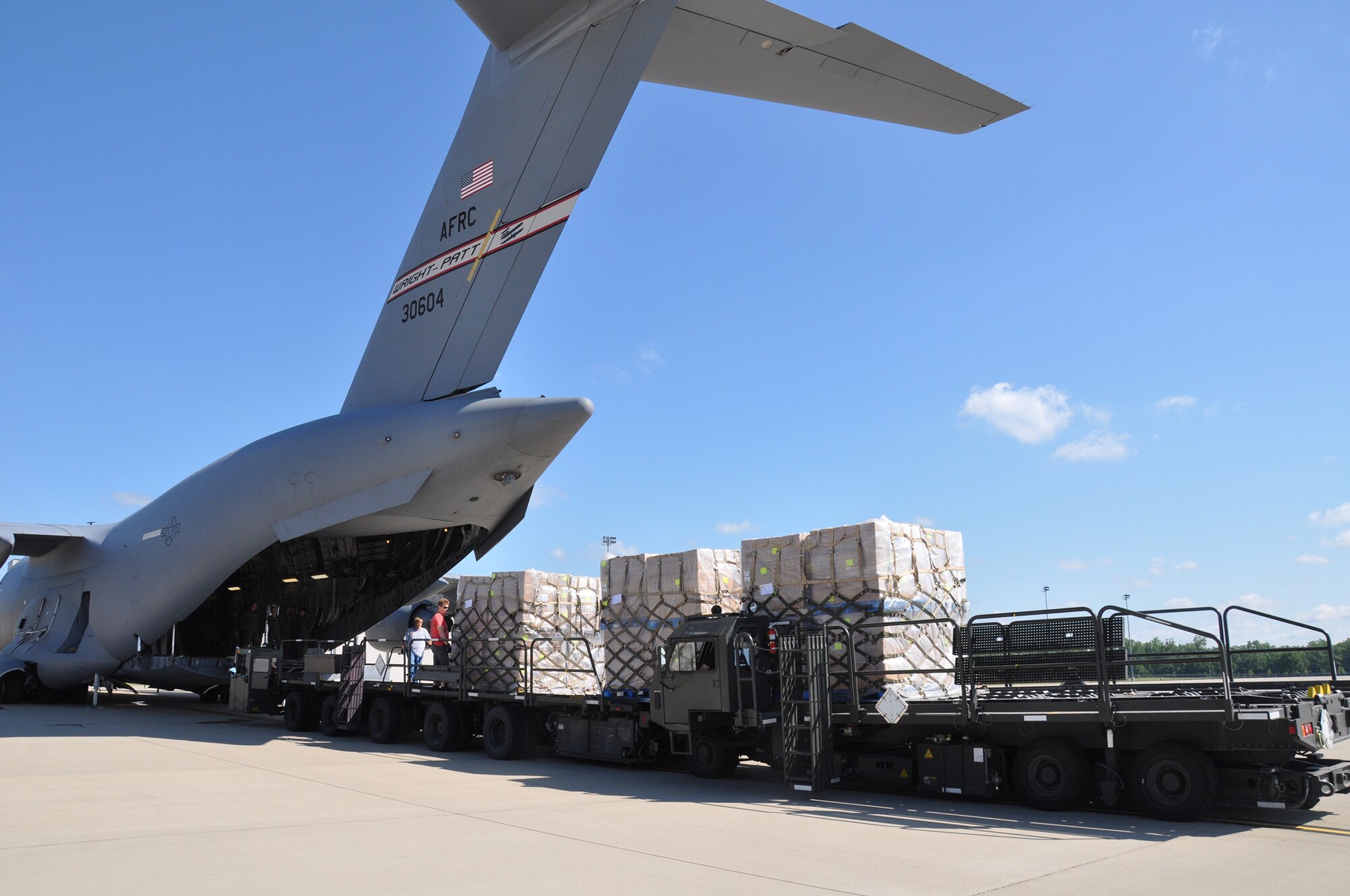 WRIGHT-PATTERSON AIR FORCE BASE, Ohio – Ten pallets containing approximately 90,000 pounds of dried and sealed food packets, the equivalent of 541,728 meals, are loaded onto a  445th Airlift Wing C-17 Globemaster III June 14 for delivery to Haiti. The food, provided by Kids Against Hunger, a ministry of A Child’s Hope International from Cincinnati, is being transported to Haiti as part of the Denton Program. The Denton Program is administered by the U.S. Agency for International Development, Department of State and Department of Defense. This allows U.S. based non-governmental sources to transport humanitarian aid at little or no cost to the donor, while simultaneously putting the extra space on U.S. military transport assets to good use. (U.S. Air Force photo/Stacy Vaughn)