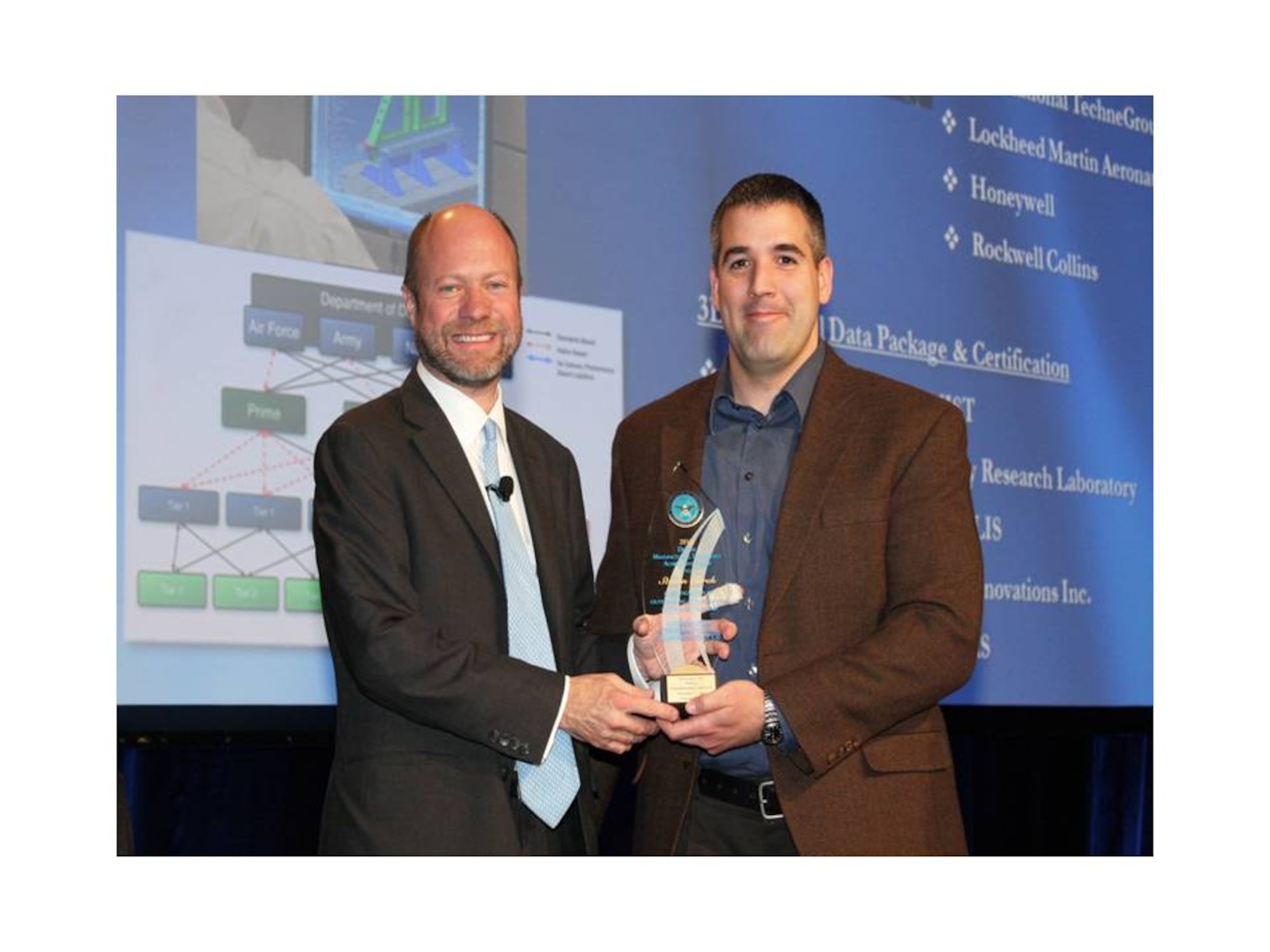 AFRL’s Steven Turek (right) receives the 2012 Defense Manufacturing Achievement Award from Brett B. Lambert, Deputy Assistant Secretary of Defense, Manufacturing Industrial Base Policy. (AFRL image)