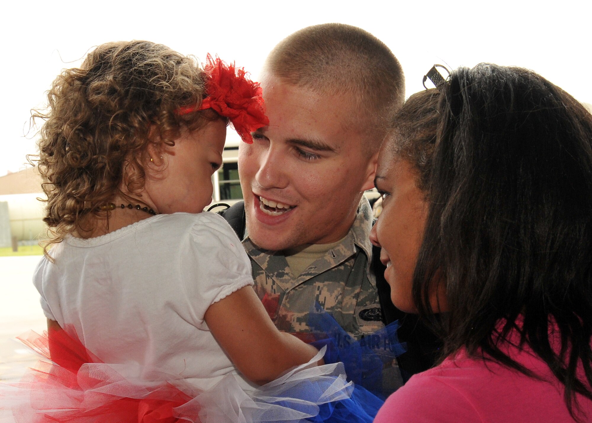 Senior Airman Alex Anderson, 55th Operations Support Squadron, holds his daughter Aviana and his wife Alisha at the Bennie Davis Maintenance Facility at Offutt Air Force Base, Neb., June 14. Team Offutt family members, friends and coworkers welcomed nearly 200 Airmen upon their return from a deployment to Southwest Asia. (U.S. Air Force photo by Tech. Sgt. Markus M. Maier/Released)