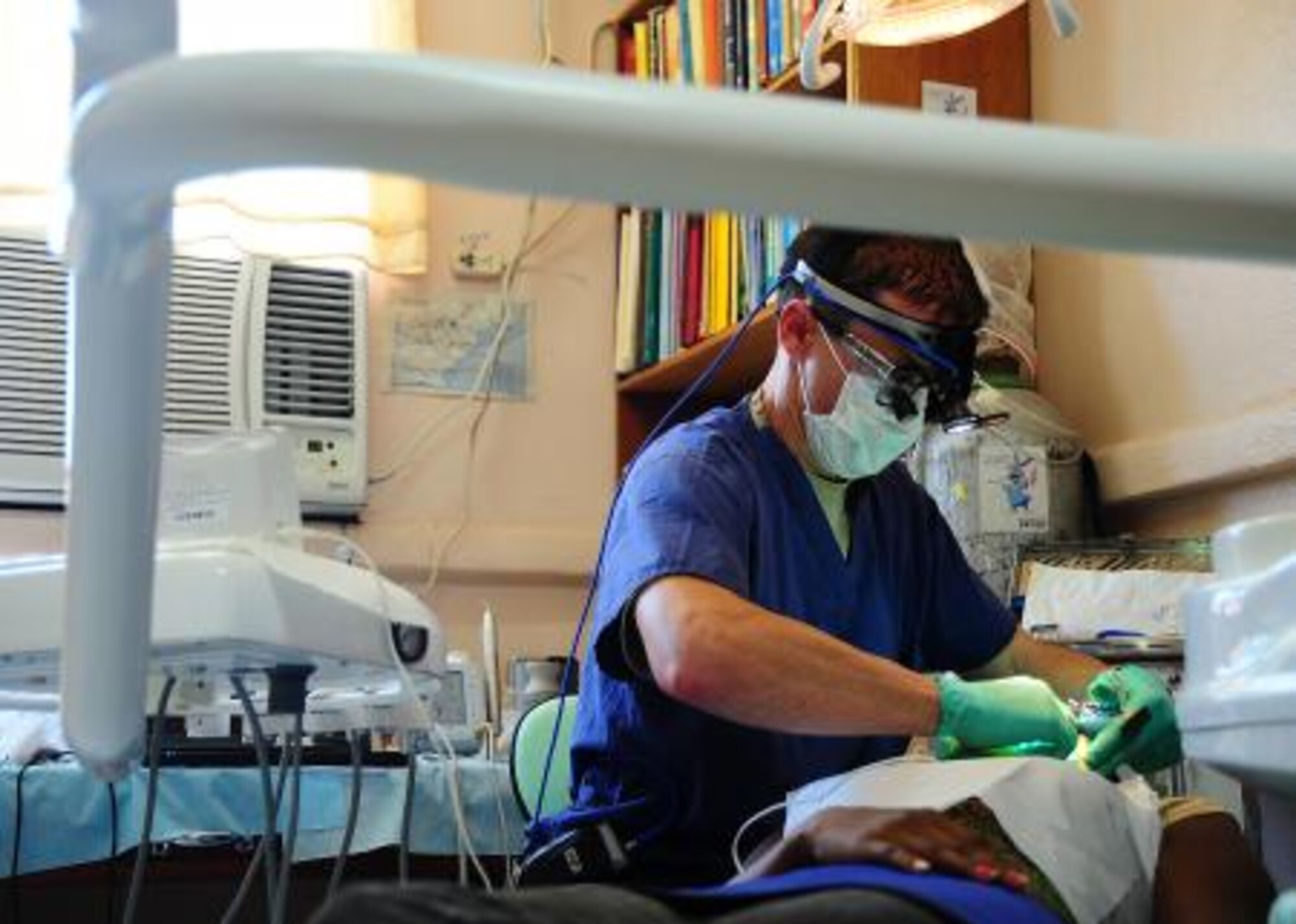 Maj. (Dr.) Mark Roberts, 81st Dental Squadron endodontist, performs a root canal during a dental readiness training exercise at the Punta Gorda Hospital annex in Punta Gorda, Belize, April 26.  Dental professionals from the U.S. and Canada are providing free dental treatment at militaple readiness training exercise throughtout Belize as part of an exercise known as “New Horizons.”  The training exercises are designed to provide medical and dental care to people throughout Belize, while helping improve the skills of U.S. and Canadian military medical forces.  (U.S. Air Force photo by Tech. Sgt. Tony Tolley)