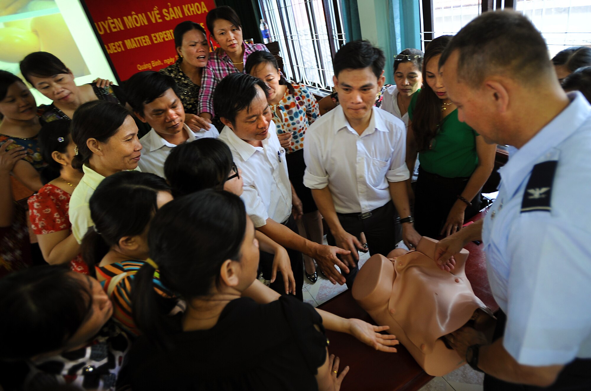 U.S. Air Force Col. John Fischer, an obstetrics and gynecology doctor at the Walter Reed National Military Medical Center Bethesda, Maryland, teaches the hands-on portion of the Prenatal/Obstetrics Emergency Subject Matter Expert Exchange to midwives and physicians from the local community in Dong Hoi, Quang Binh Province, as part of Operation Pacific Angel, June 10, 2013. Operation PACANGEL is a joint and combined humanitarian assistance exercise held in various countries several times a year and includes medical, dental, optometry, engineering programs and a variety of SMEEs. (U.S. Air Force photo by Staff Sgt. Sara Csurilla)