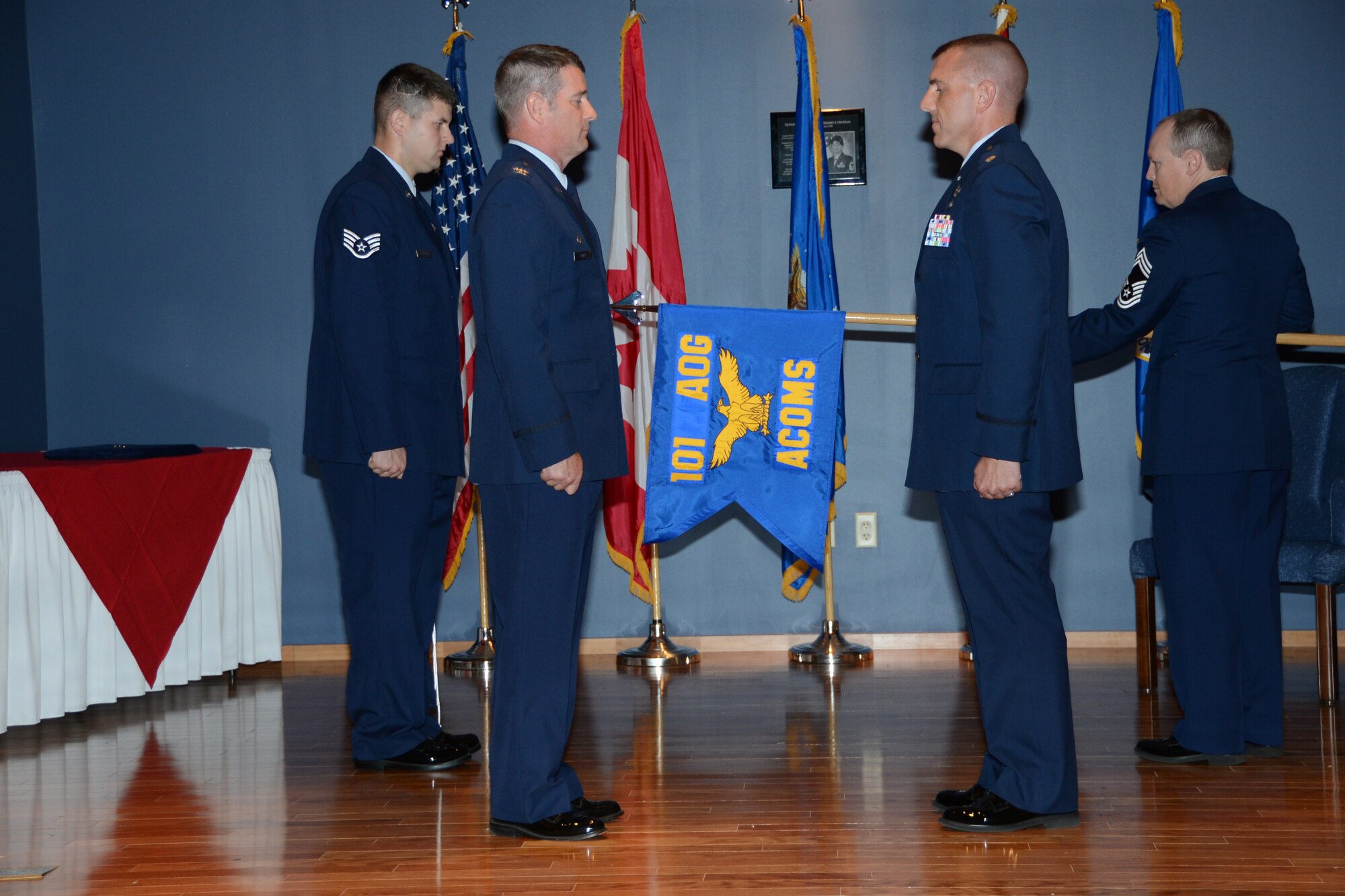 From left, Staff Sgt. Dylan Gooding, 101st Air Communications Squadron Test Flight, Col. John Ferry, 101 Air and Space Operations Group commander, Lt. Col. Dave Wiley, 101st ACOMS commander and Chief Master Sgt. Ewell Griswold, participate in the 101st ACOMS activation June 8. U.S. Air Force photo by Maj. Steve Burke