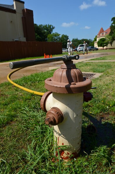 Airman 1st Class Clifton Watkins, 2nd Civil Engineer Squadron, pulls a charged fire hose on Barksdale Air Force Base, La., June 13, 2013. Watkins completed his annual self contained breathing apparatus certification and firefighter fitness test. (U.S. Air Force photo/Senior Airman Micaiah Anthony) 