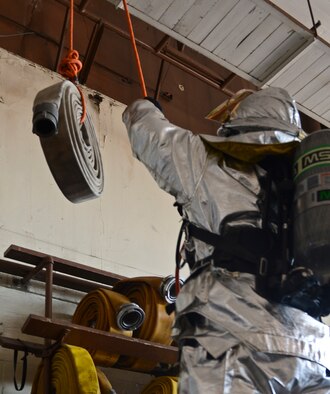 Airman 1st Class Clifton Watkins, 2nd Civil Engineer Squadron, pulls a hose on Barksdale Air Force Base, La., June 13, 2013. Watkins completed his annual self contained breathing apparatus certification and firefighter fitness test. (U.S. Air Force photo/Senior Airman Micaiah Anthony)