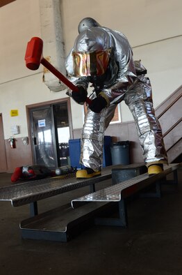 Airman 1st Class Clifton Watkins, 2nd Civil Engineer Squadron, uses a hammer to hit a sled on Barksdale Air Force Base, La., June 13, 2013. Hammering the sled is a training exercise used to simulate ventilation techniques. (U.S. Air Force photo/Senior Airman Micaiah Anthony)