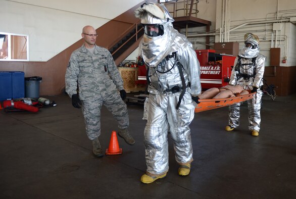 Staff Sgt. Adam Mercer and Airman 1st Class Clifton Watkins, 2nd Civil Engineer Squadron, carry a training dummy on a stretcher on Barksdale Air Force Base, La., June 13, 2013. Mercer and Watkins completed their annual self contained breathing apparatus certification and firefighter fitness test. (U.S. Air Force photo/Senior Airman Micaiah Anthony)