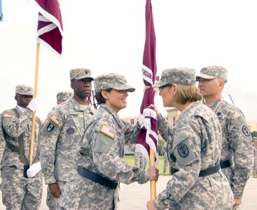 Lt. Gen. Patricia D. Horoho (second from right), Army Surgeon General and U.S. Army Medical Command commanding general, passes the Southern Regional Medical Command guidon to Maj. Gen. Jimmie O. Keenan, incoming SRMC commanding general, while Command Sgt. Maj. Marshall L. Huffman and outgoing commanding general Maj. Gen. M. Ted Wong look on during the SRMC change of command June 6. (U.S. Army Photo by Erin Perez, Southern Regional Medical Command Public Affairs)