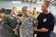 Airman 1st Class Brandon Lopez, 436th Logistics Readiness Squadron (middle) smiles after the shock from a Tazer has ended during a capabilities demonstration for Dover Air Force Base, Del. Honorary Commanders by the 436th Security Forces Squadron, Raven section, June 5, 2013. (U.S. Air Force photo/Greg L. Davis)