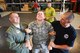 Senior Airman Samual Taylor, 436th Airlift Wing Public Affairs Office (middle) is supported by two members of the 436th Security Forces Squadron, Raven section, as Taylor receives a shock from a non-lethal Tazer weapon while Dover Air Force Base, Del. Honorary Commanders watch a demonstration of capabilities, June 5, 2013. (U.S. Air Force photo/Greg L. Davis)