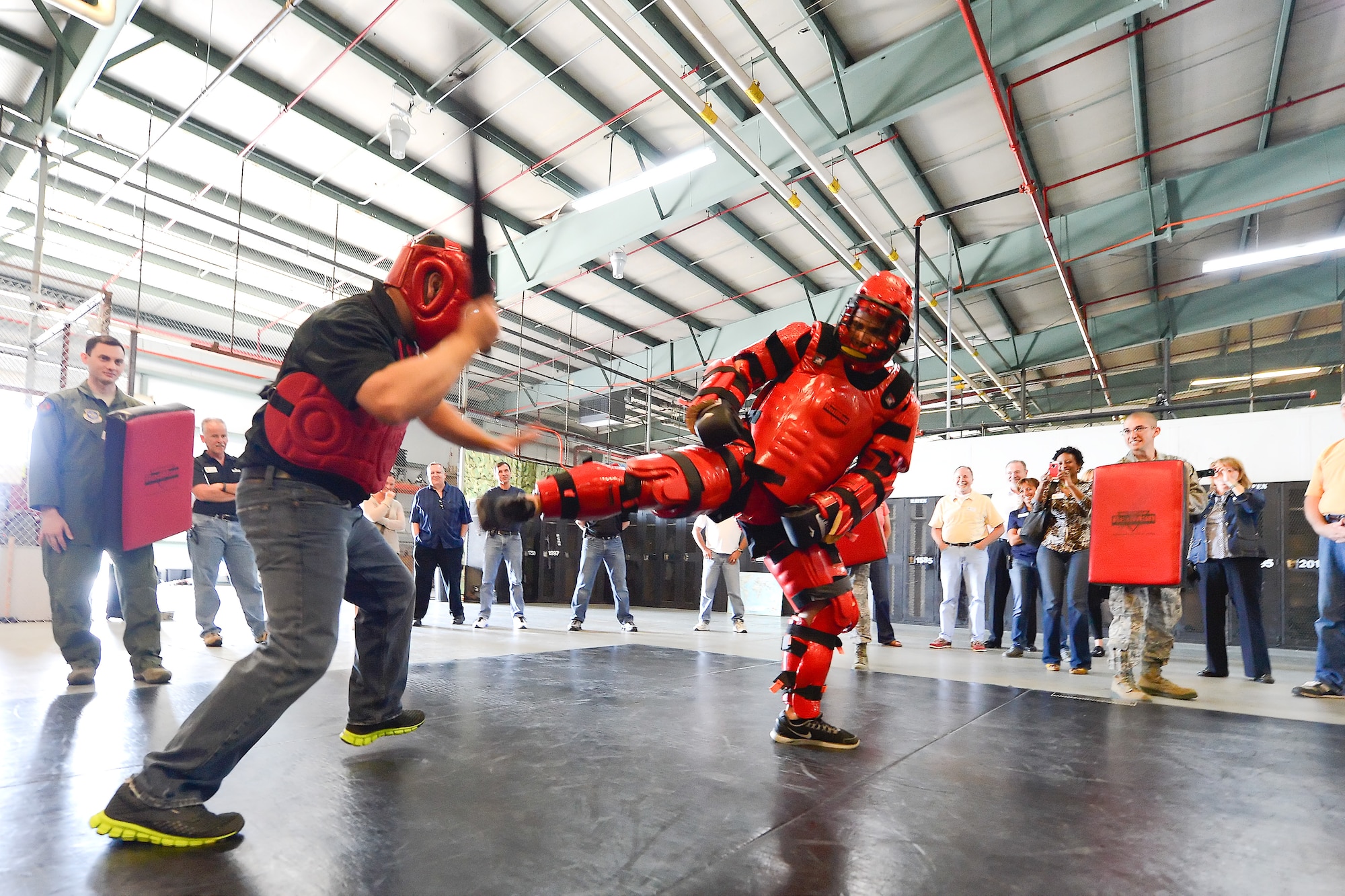 Mr. John Matarese, Honorary Commander for the 709th Airlift Squadron, (wearing jeans) weilds a simulated ASP baton while sparring with a 436th Security Forces Squadron member wearing a protective red suit to experience some of the training Raven's go through during an in-depth tour of Dover Air Force Base, Delaware's 436th Security Forces Squadron, June 5, 2013. Raven's are highly trained Security Forces personnel who deploy with military aircraft and provide on-site security for the aircraft around the world.  (U.S. Air Force photo/Greg L. Davis)