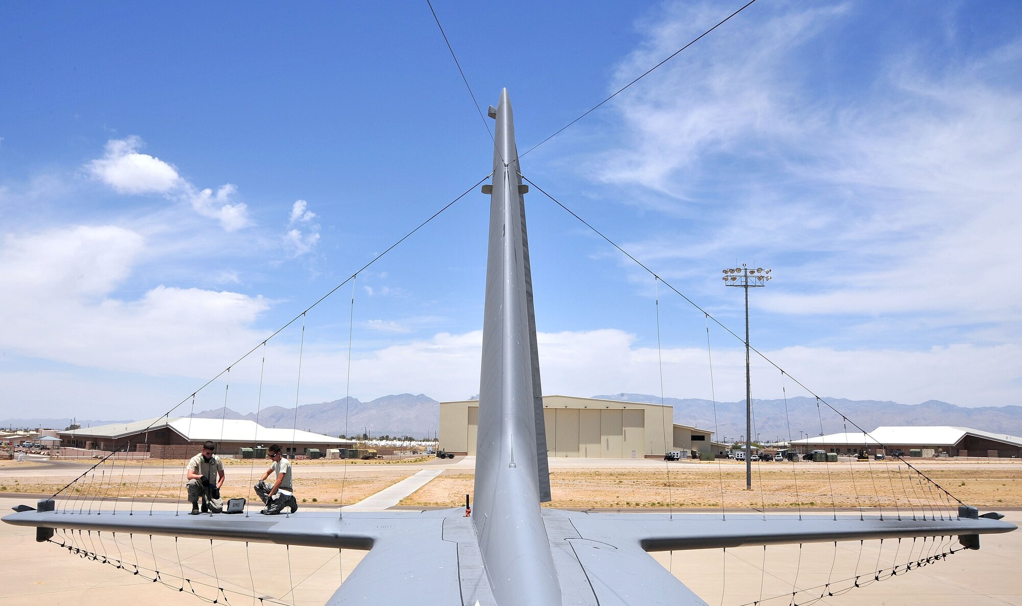 U.S. Air Force Staff Sgt Carl Schmidt (left) and Airman 1st Class Ryan Hughes (right), 755th Aircraft Maintenance Squadron aerospace maintenance journeymen, perform a pre-flight inspection at Davis-Monthan Air Force Base, Ariz., June 12, 2013. The 755th AMXS plans and executes all on-equipment maintenance actions for 14 EC-130H and one TC-130H aircraft, including launch and recovery, scheduled inspections, servicing and component replacement.(U.S. Air Force photo by Airman 1st Class Josh Slavin/Released)