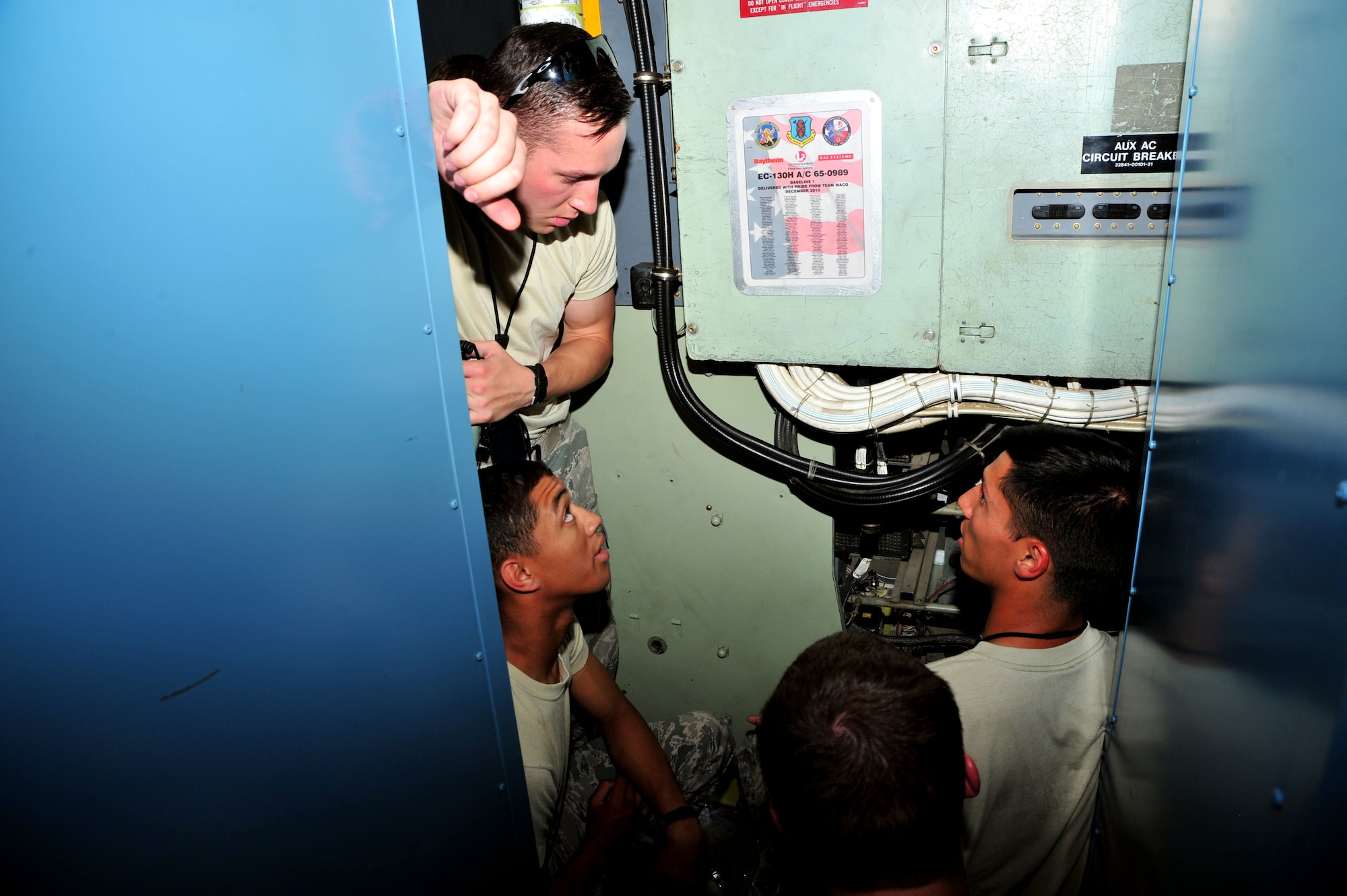 U.S. Air Force Airmen from the 755th Aircraft Maintenance Squadron familiarize themselves with the EC-130H at Davis-Monthan Air Force Base, Ariz., June 12, 2013. The Airmen are recent technical school graduates, and are receiving on the job training.(U.S. Air Force photo by Airman 1st Class Josh Slavin/Released)