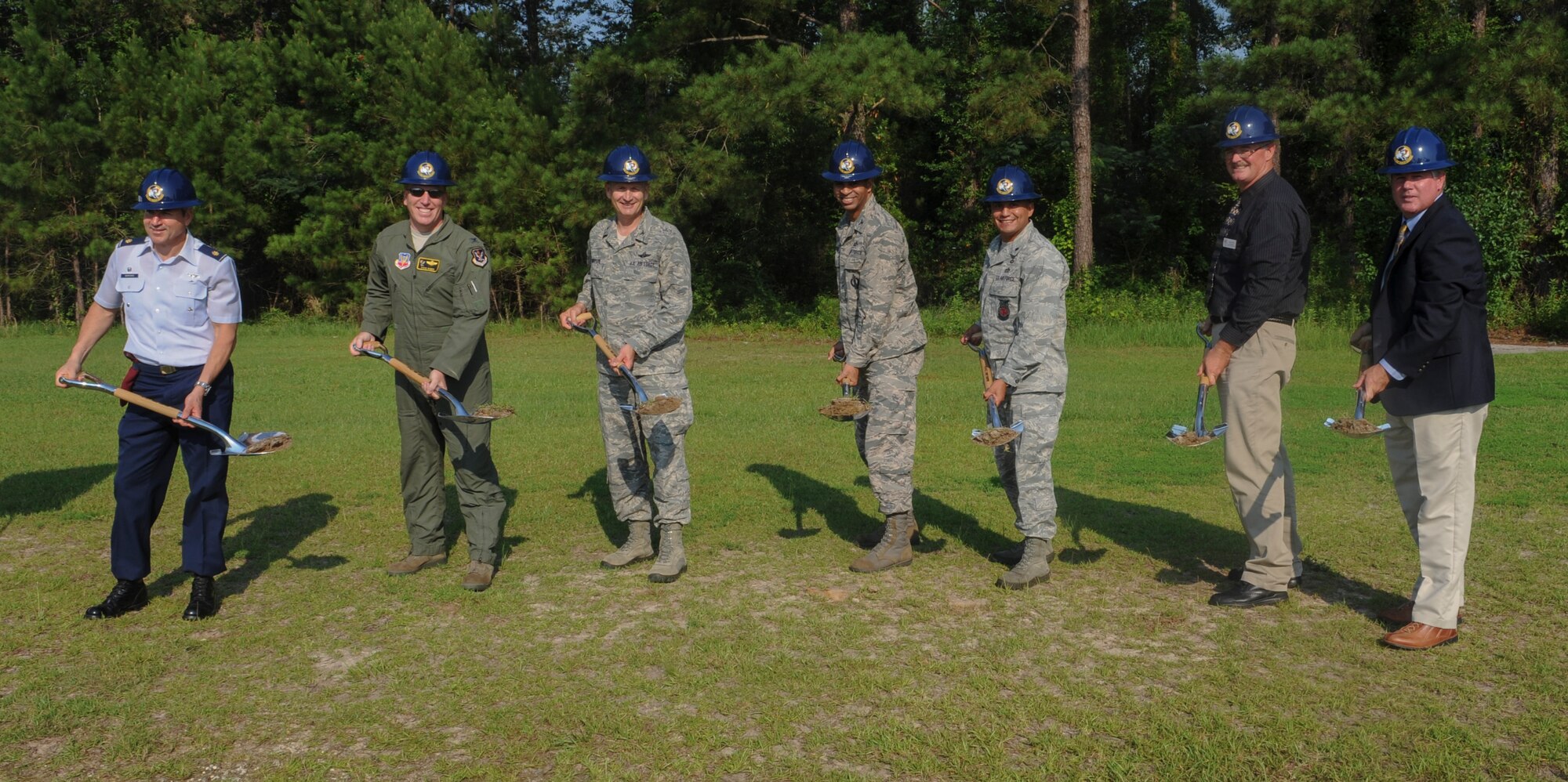 Wing leadership and contractors shovel dirt at the ground breaking ceremony for the HC-130 Combat King II Simulator Facility at Moody Air Force Base, Ga., June 13, 2013. The HC-130J Simulator Facility will also provide space for the HH-60G Pave Hawk fixed flight simulator.(U.S. Air Force photo by Airman Alexis Grotz/Released)