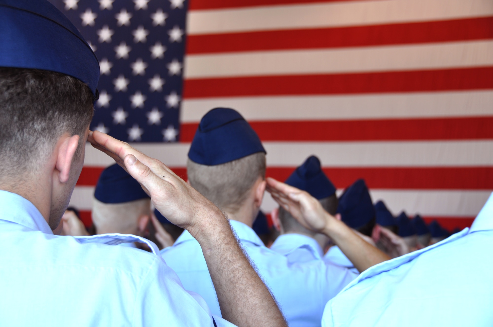 Airmen of the 552nd Air Control Wing salute to the colors during the presentation of the U.S. National Anthem at the 552nd ACW change of command ceremony at Tinker Air Force Base, June 13.  (U.S. Air Force Photo/Maj. Jon Quinlan)