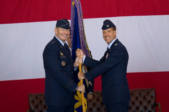 The commander of 12th Air Force (Air Forces Southern), Lt. Gen. Robin Rand (left), passes the 552nd Air Control Wing guidon to Col. Jay Bickley and with it, command of the 552nd ACW at a ceremony at Tinker Air Force Base, June 13. Colonel Bickley replaced departing commander, Col. Gregory Guillot who will lead the 55th Wing at Offutt Air Force Base, Neb. (U.S. Air Force photo/Master Sgt. Thomas Edwards) 