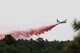 An aircraft releases a fire-retardant solution to help stop the spreading of the burning fires at Black Forest, Colo., June 12, 2013. (U.S. Air Force photo by Senior Airman Kendra Alba)