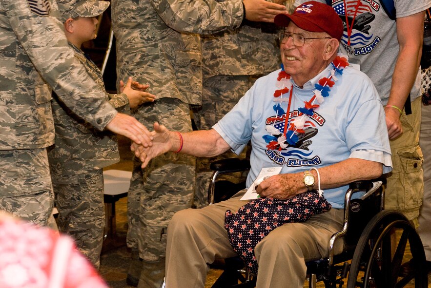 A U.S. Armed Forces veteran receives a warm welcome after returning home from the inaugural Greater Peoria Honor Flight at the General Wayne A. Downing Peoria International Airport in Peoria, Ill., June 4, 2013.  American war veterans and their volunteer guardians were flown from Peoria to Washington, D.C., in order to see their respective memorials in person before age and disability would make it impossible to do so later.  That evening, members of the Illinois Air National Guard’s 182nd Airlift Wing and other current service members gathered at the airport terminal in uniform to personally welcome the veterans home and honor their service.  (U.S. Air National Guard photo by Staff Sgt. Lealan Buehrer/Released)