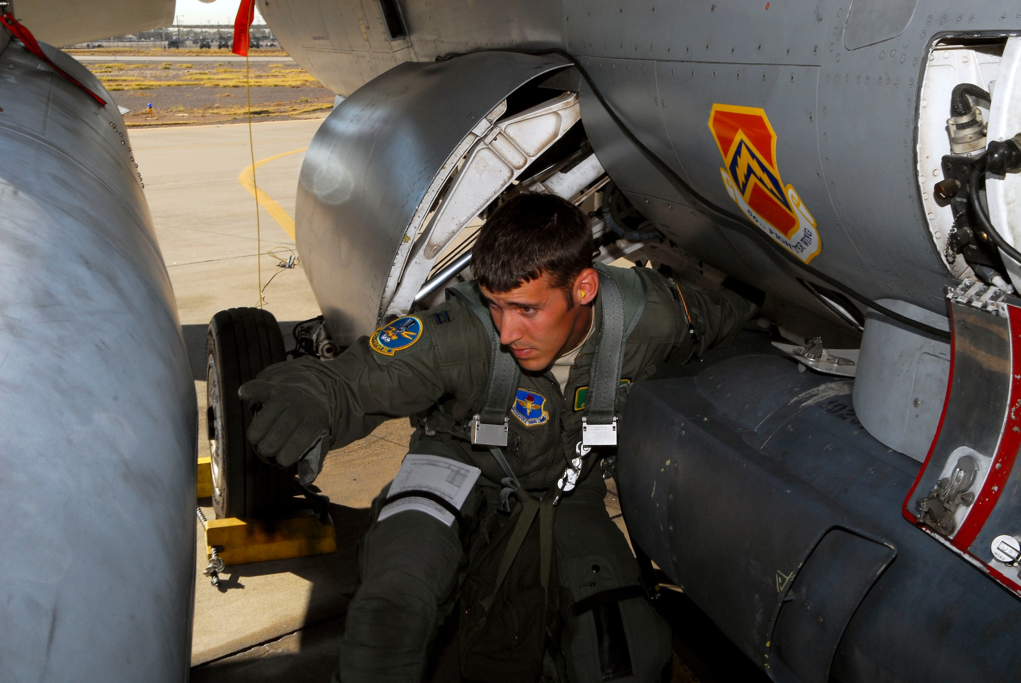 Capt. Dakota Olsen, 310th Fighter Squadron student pilot, performs a preflight check during his training at Luke Air Force Base. (U.S. Air Force photo by Senior Airman David Owsianka)