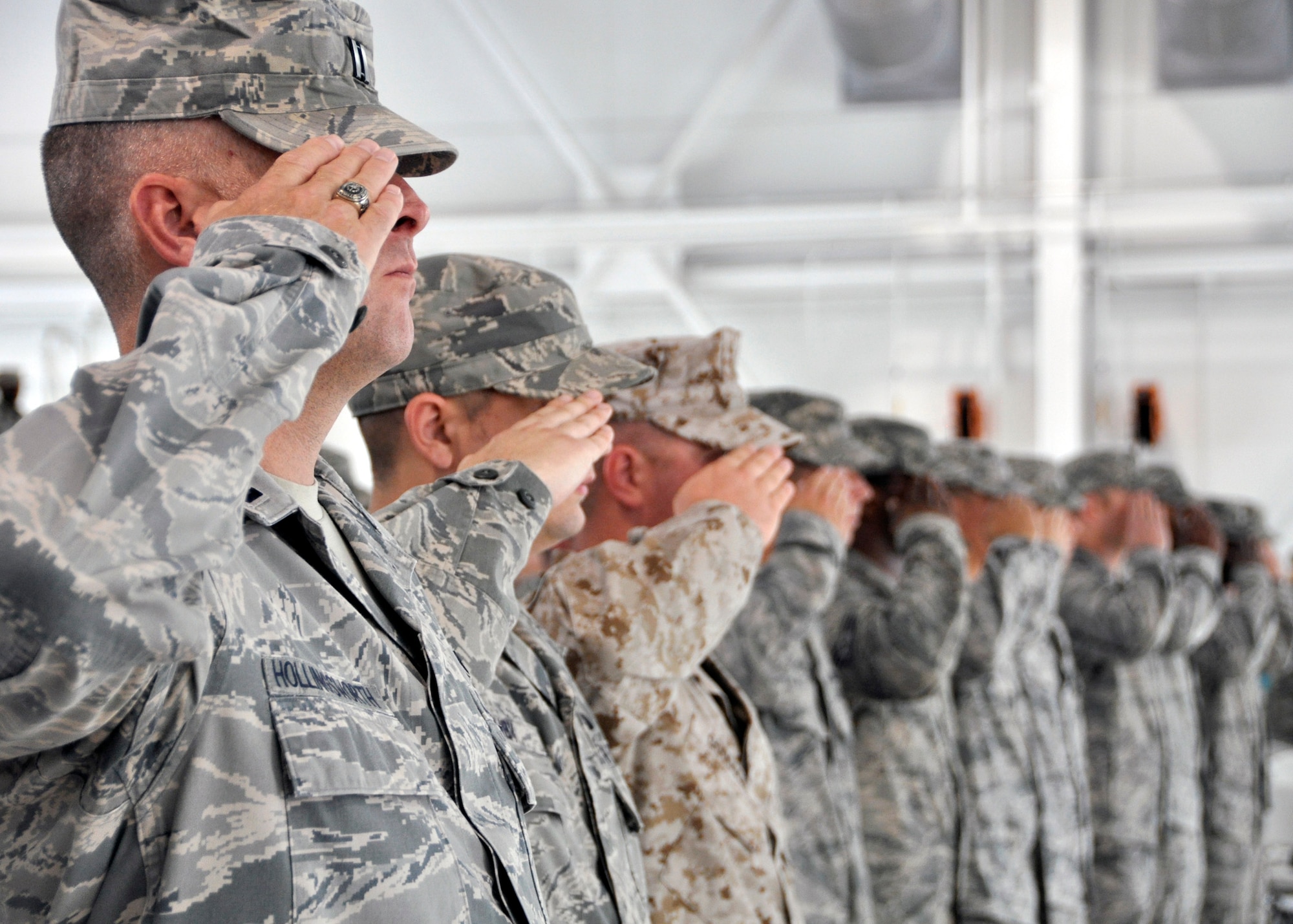 Airmen and Marines with the 33rd Fighter Wing salute the flag during the National Anthem at the change of command ceremony June 14 at Eglin Air Force Base, Fla. Col. Todd Canterbury took command of the wing from Col. Andrew Toth, who leaves to become director of assignments at Joint Base San Antonio-Randolph, Texas. (U.S. Air Force photo/Sara Vidoni)