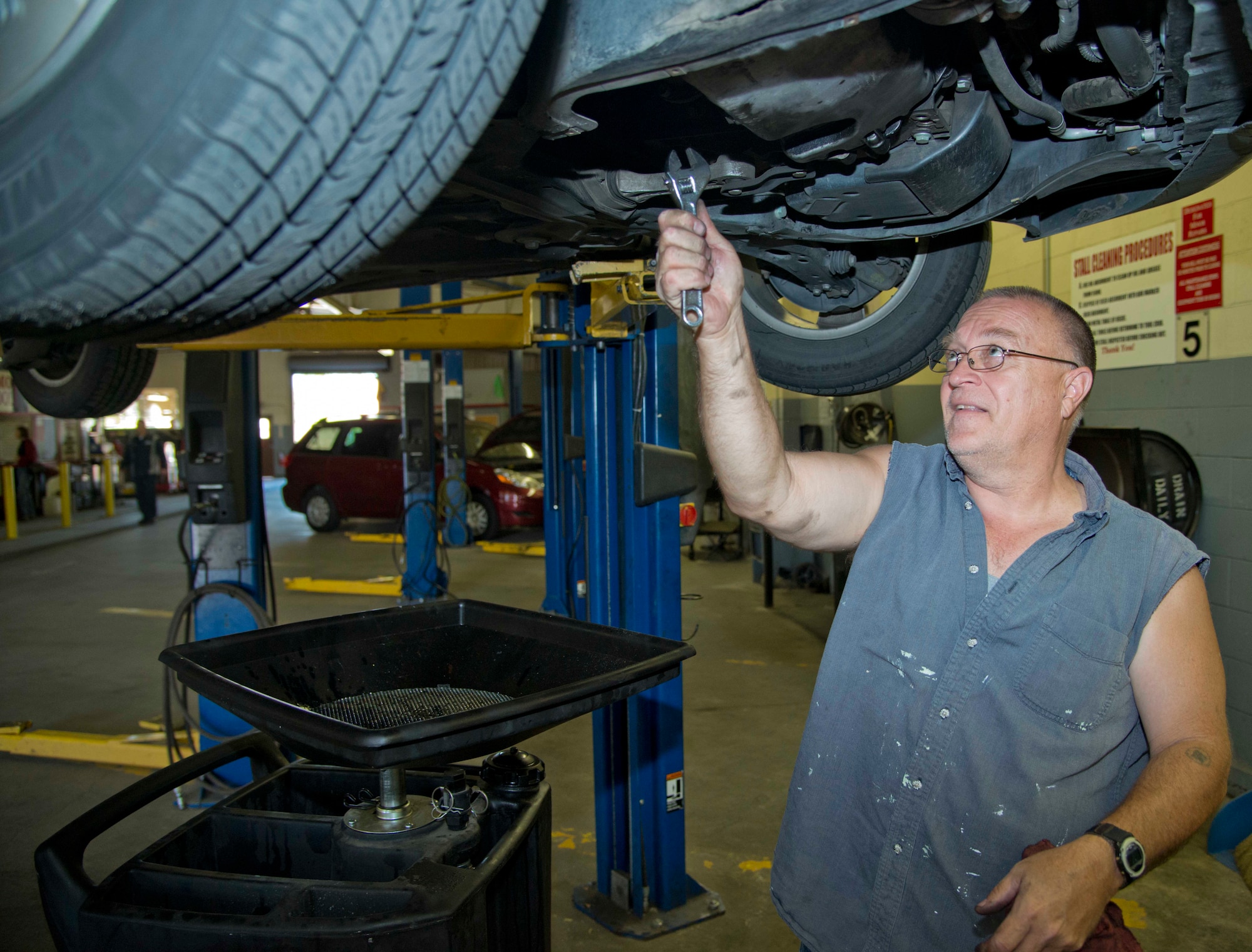Retired Cheif Master Sgt. Steve Rotondo, who served with the 60th Civil Engineer Sqaudron, does an oil change on his Volkswagan Jetta TDI at the base Auto Hobby Shop June 11, 2013. (U.S.Air Force photo/Airman 1st Class Nicole Leidholm)