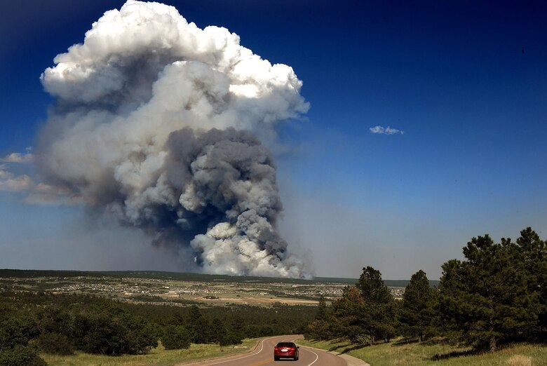 The Black Forest Fire smolders several miles east of the U.S. Air Force Academy in this shot taken near the Cadet Chapel June 11, 2013, in Colorado Springs, Colo. The fire burned between 7,500 and 8,000 acres the first day approximately 100 homes. More than 5,000 people were evacuated from an additional 1,700 homes. (U.S. Air Force photo/Carol Lawrence)