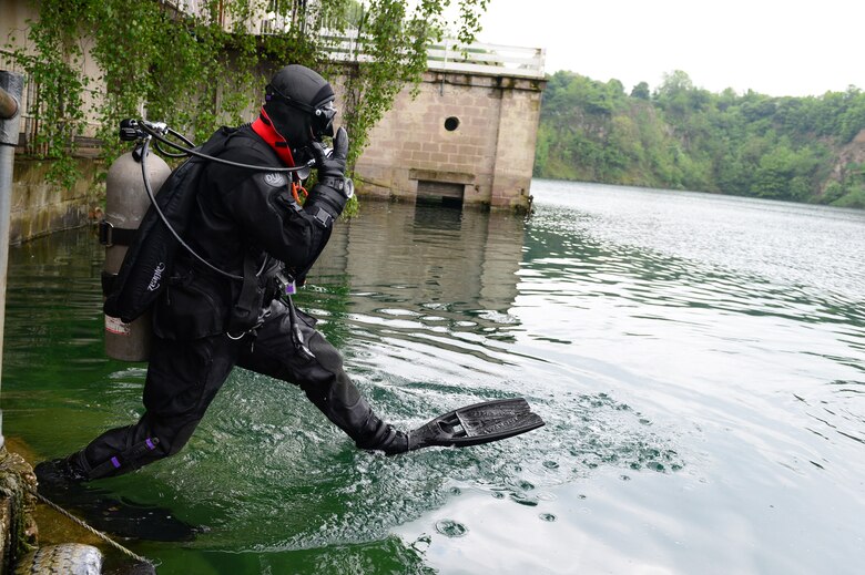 Senior Airman Chris Sanders enters the water during rescue dive training May 30, 2013, in Stoney Cove, England. Pararescuemen trained in a controlled environment allowing them to focus on their curriculum without being disturbed. Sanders is a pararescueman assigned to the 56th Rescue Squadron (U.S. Air Force photo/Senior Airman Lausanne Morgan)