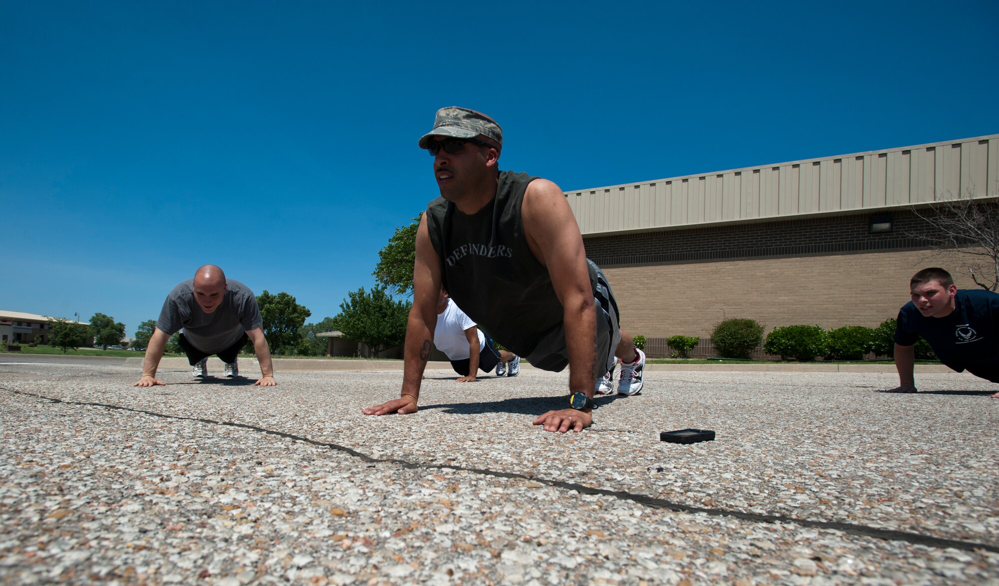 Tech. Sgt. Terrance Williams, 22nd Air Refueling Wing Honor Guard NCO in charge, leads a group PT session June 11, 2013 at McConnell Air Force Base, Kan. As the NCOIC, Williams is responsible for managing his Airmen during the duty day, which includes following the training schedule, arranging details and monitoring each flight’s progress. (U.S. Air Force photo/Airman 1st Class Victor J. Caputo)
