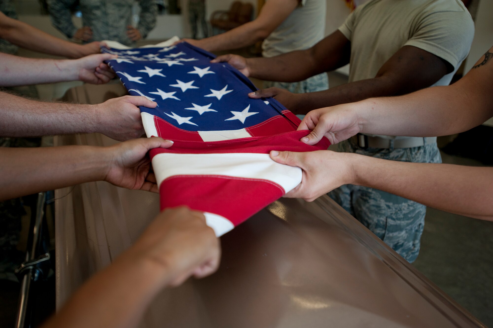 An American flag is folded by the 22nd Air Refueling Wing Honor Guard June 11, 2013 at McConnell Air Force Base, Kan. The folding and presenting of the flag is part of every full-honors veteran burial service they perform. (U.S. Air Force photo/Airman 1st Class Victor J. Caputo)