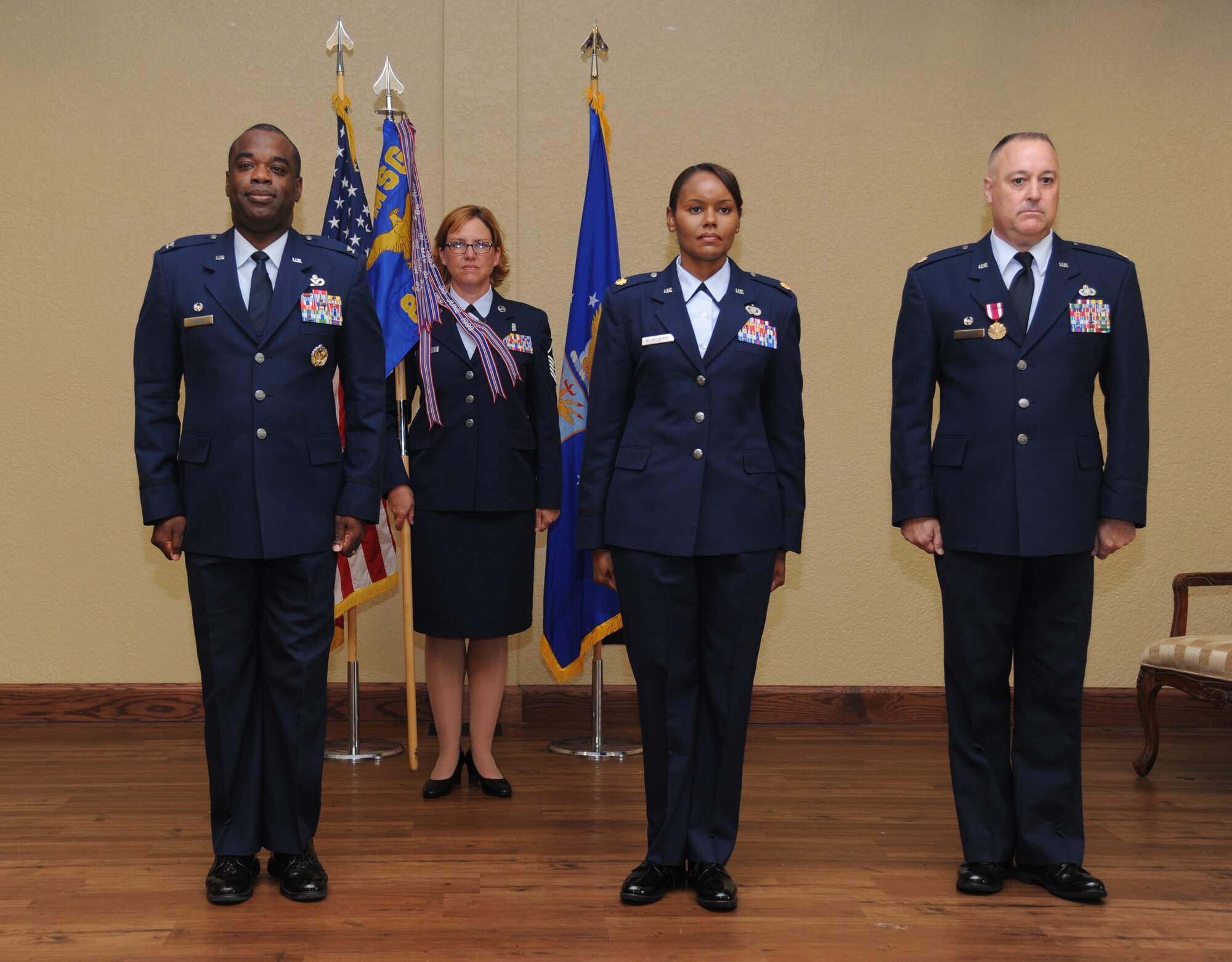 Col. Mark Vivians, 81st Mission Support Group commander; Maj. Sharon Nickelberry, incoming 81st Force Support Squadron commander; and Maj. John Ponton, outgoing 81st FSS commander complete an exchange of the guidon as Nickelberry assumes command during the 81st FSS change of command ceremony June 14, 2013, at the Bay Breeze Event Center, Keesler Air Force Base, Miss.  Vivians served as the presiding officer for the event.  (U.S. Air Force photo by Kemberly Groue)