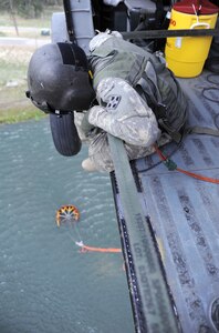 The crew of a UH-60 Black Hawk helicopter fills a Bambi Bucket in a reservoir during the fight against the Black Forest Fire June 13, 2013. The crew is assigned to the 4th Combat Aviation Brigade, 4th Infantry Division, at Fort Carson, Colo. (U.S. Air Force photo/Capt. Richard Ricciardi)
