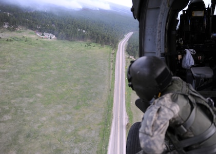 The crew of a UH-60 Black Hawk helicopter surveys the Black Forest Fire from above State Highway 83 June 13, 2013. The crew is assigned to the 4th Combat Aviation Brigade, 4th Infantry Division, at Fort Carson, Colo. (U.S. Air Force photo/Capt. Richard Ricciardi)