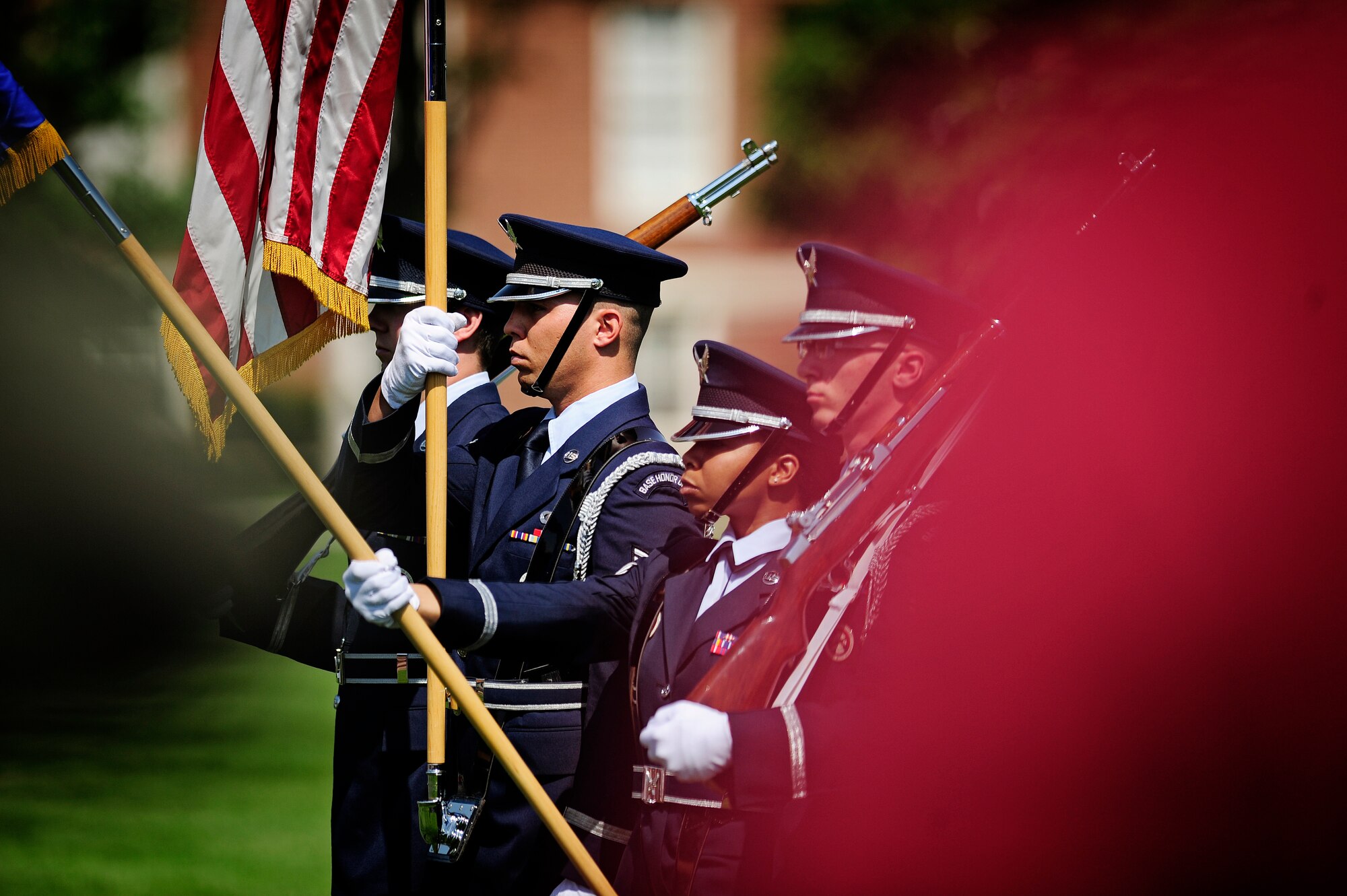 The Scott Air Force Base honor guard present the flag during the playing of the National Anthem at the 375th Air Mobility Wing change of command ceremony June 14, 2013 at Scott AFB, Ill. Col. Kyle Kremer, former vice commander at McConnell AFB, assumed command from Col. David Almand, who was selected to be the wing commander of the 89th Airlift Wing at Andrews.(U.S. Air Force photo/ Staff Sgt. Ryan Crane)