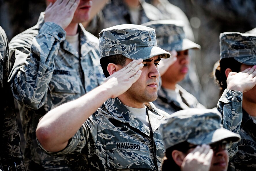 Airmen salute the flag during the playing of the National Anthem at the 375th Air Mobility Wing change of command ceremony June 14, 2013 at Scott Air Force Base, Ill. Col. Kyle Kremer, former vice commander at McConnell AFB, assumed command from Col. David Almand, who was selected to be the wing commander of the 89th Airlift Wing at Andrews.(U.S. Air Force photo/ Staff Sgt. Ryan Crane)