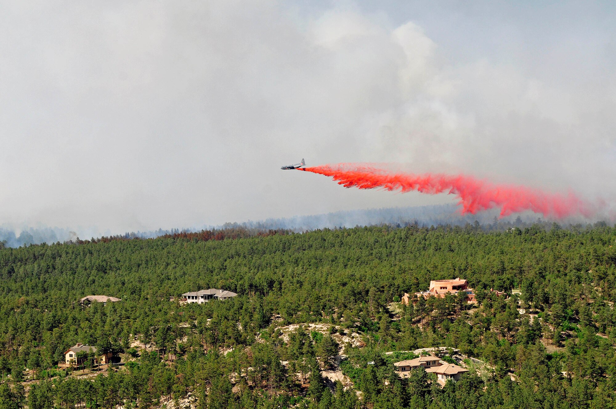 A Modular Airborne Firefighting System-equipped C-130 from the 302nd Airlift
Wing releases a fire-retardant solution to help stop the spreading of fires
at Black Forest, Colo., June 12, 2013. (U.S. Army photo by Sgt. Jonathan C.
Thibault/Released)
