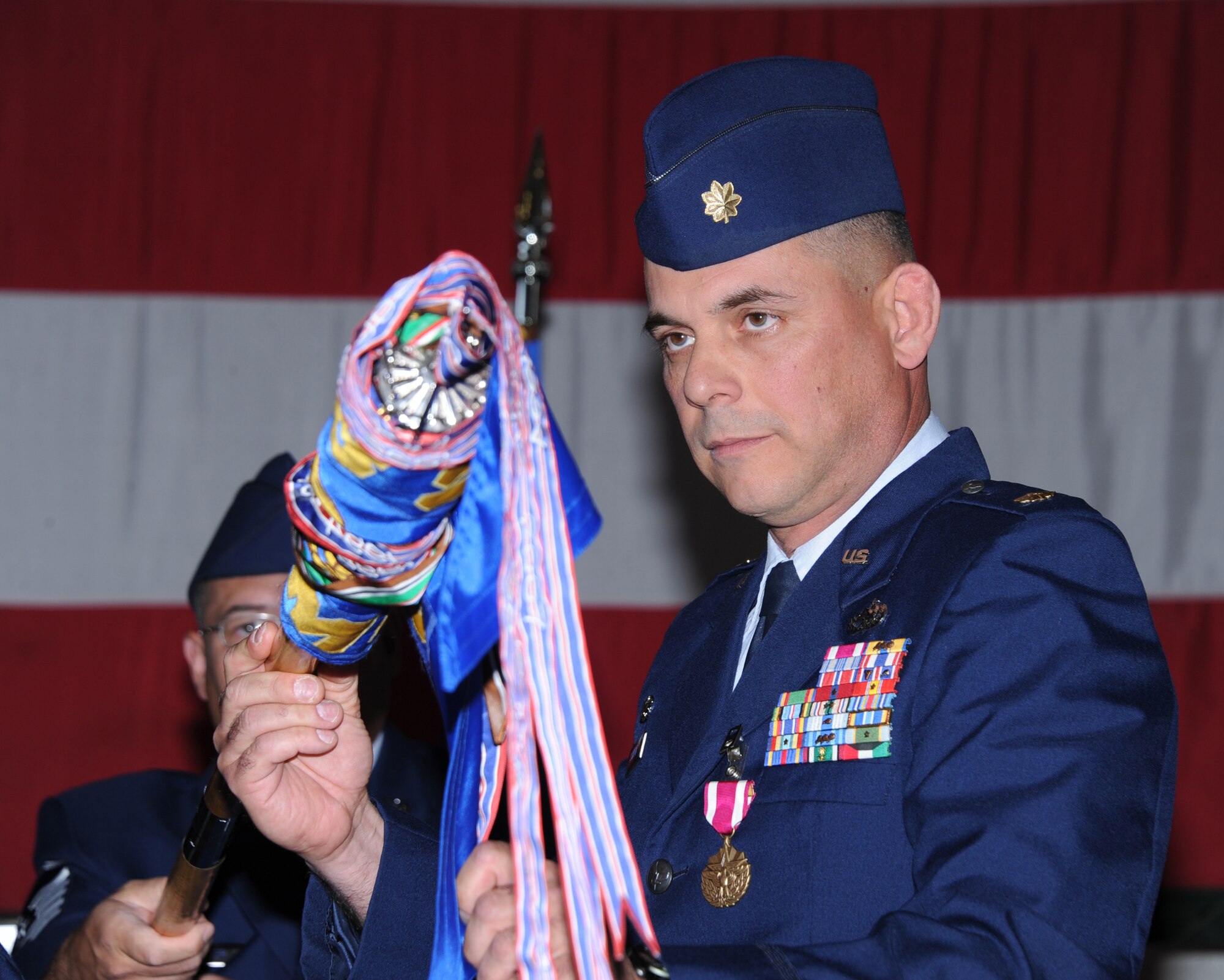 Maj. Michael Scianna, former commander of the 58th Maintenance Operations Squadron, furls the unit's guidon at the inactivation ceremony.  (Photo by Todd Berenger)