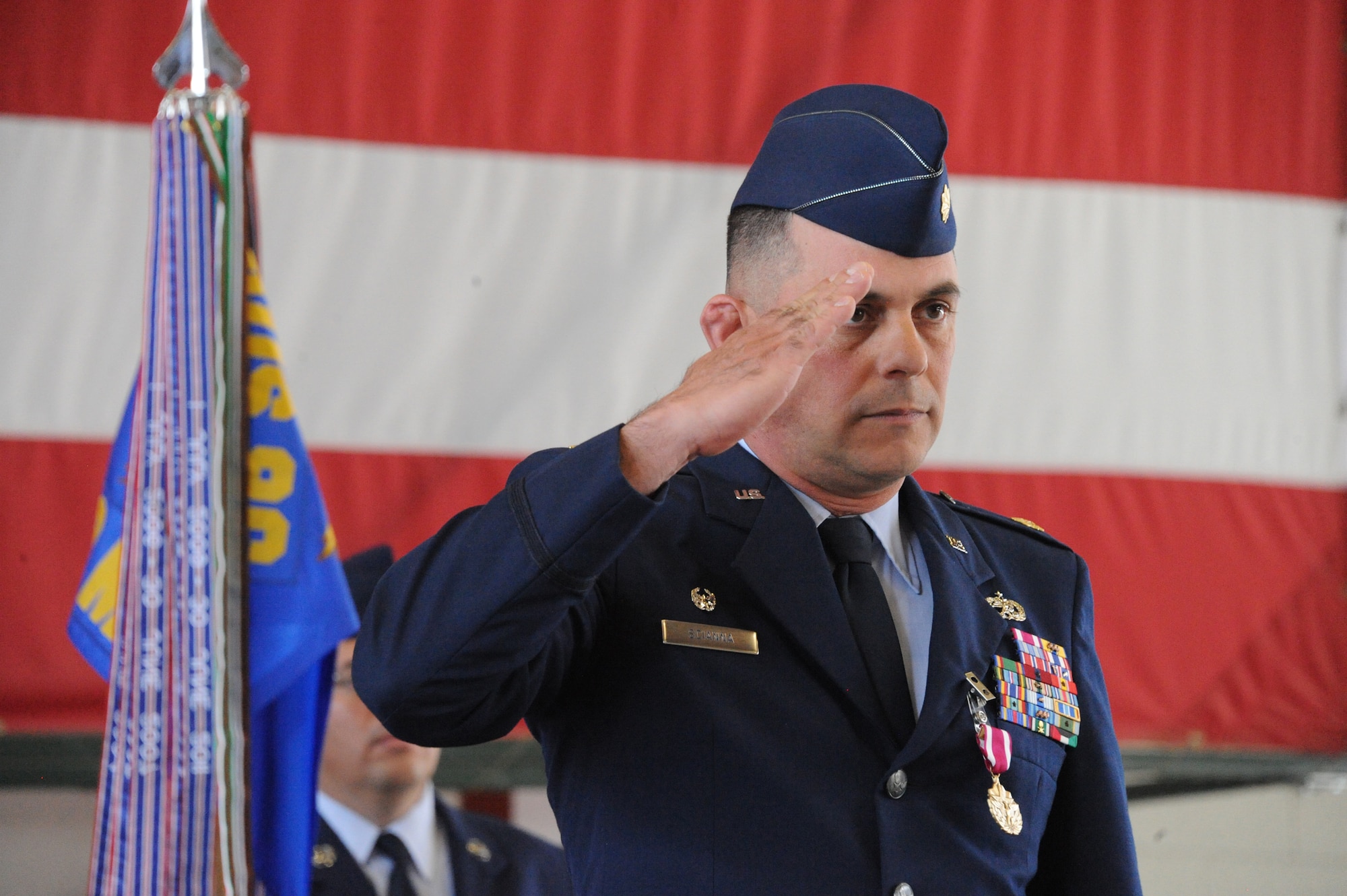 Maj. Michael Scianna, former commander of the 58th Maintenance Operations Squadron, gives a final salute to members of the now-inactivated unit. (Photo by Todd Berenger)