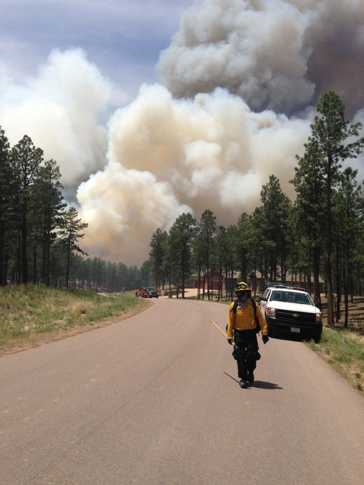 A firefighter from the 721st Civil Engineer Squadron fire department at Cheyenne Mountain Air Force Station prepares to fight the raging fires in the Black Forest region of Colorado Springs June 12. Fire fighters and other emergency service personnel have worked tirelessly around the clock to extinguish the fire that began June 11. The 21st Space Wing and 721st Mission Support Group is providing two fire trucks and 13 firefighters in response to requests under a mutual aid agreement with El Paso County Sheriff’s Department, as well as providing shelter for DOD personnel displaced by the fire. (U.S. Air Force photo)