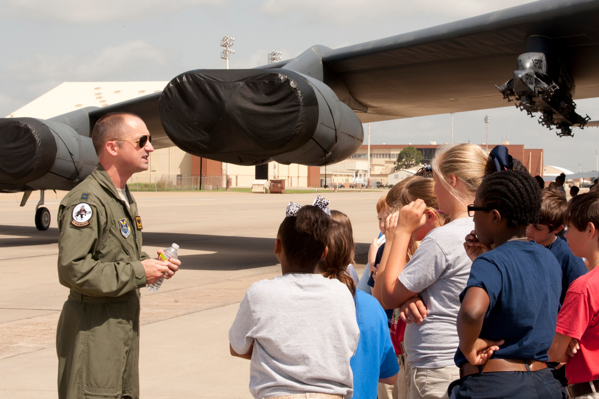 U.S. Air Force Capt. Thomas Garvin, who is an instructor radar navigator at the 93rd Bomb Squadron’s Formal Training Unit, speaks to a group of 5th grade students about the B-52 Stratofortress during a static tour at Barksdale Air Force Base, La., June 12, 2013. The students are attending STARBASE Louisiana, at Barksdale, one of 70 national STARBASE sites. It is sponsored by the 307th Bomb Wing of the Air Force Reserve Command. The program presents an exciting 25-hour hands-on minds-on Science, Technology, Engineering, and Mathematics (STEM) curriculum to area 5th grade students and their teachers. STARBASE Louisiana creates an environment to actively engage students in STEM exploration to excite their interest, develop a solid concept base, and encourage them to pursue these areas in future studies. Approximately 70 students from Shreve Island Elementary School in Caddo Parish took part in the static tour. (US Air Force photo by Betty Stephens/Released)