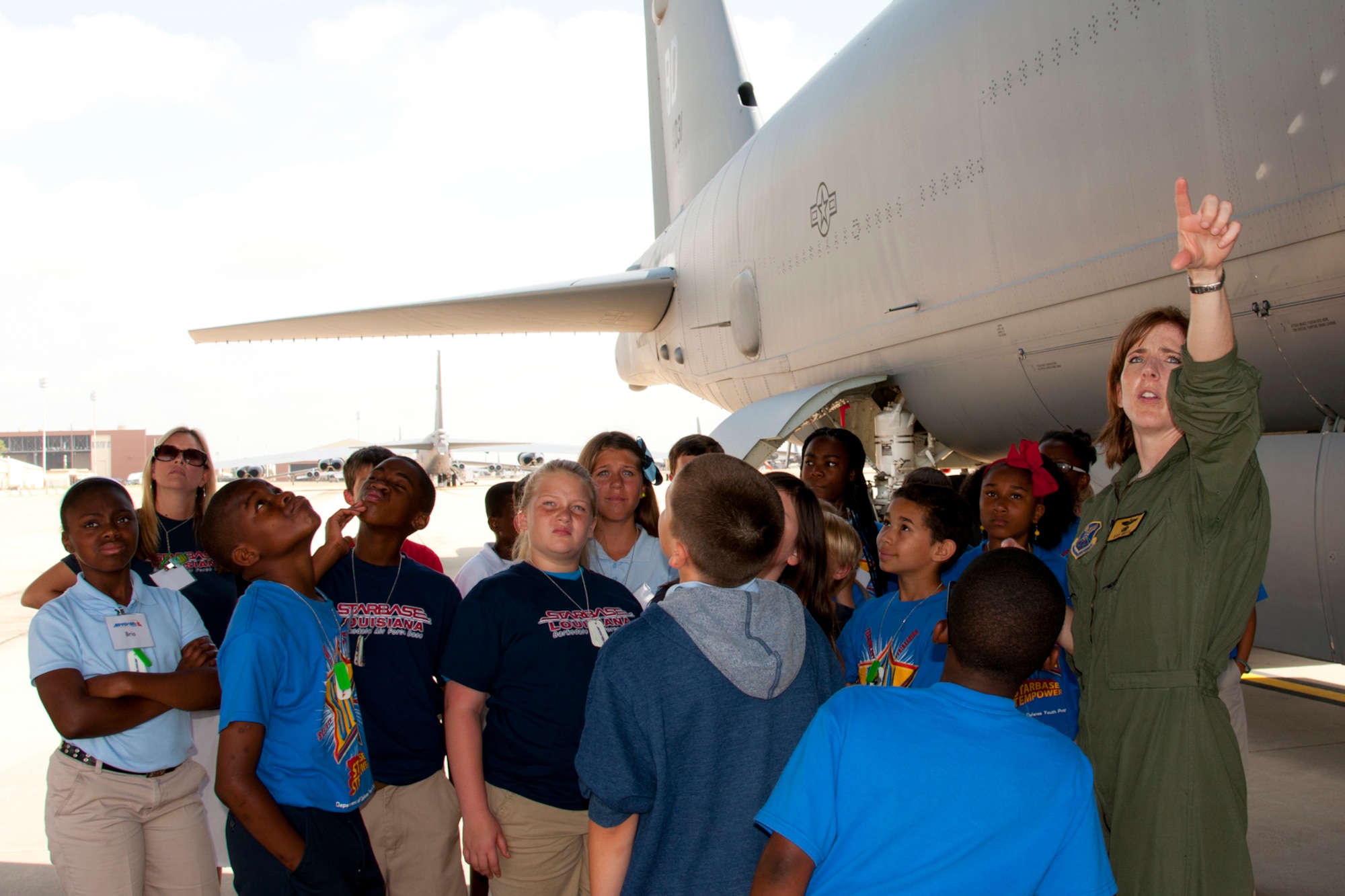 U.S. Air Force Maj. Kari Mott, who is an instructor radar navigator at the 93rd Bomb Squadron’s Formal Training Unit, explains the war-time capabilities of a B-52 Stratofortress to a group of 5th grade students during a static tour at Barksdale Air Force Base, La., June 12, 2013. The students are attending STARBASE Louisiana, at Barksdale, one of 70 national STARBASE sites. It is sponsored by the 307th Bomb Wing of the Air Force Reserve Command. The program presents an exciting 25-hour hands-on minds-on Science, Technology, Engineering, and Mathematics (STEM) curriculum to area 5th grade students and their teachers. STARBASE Louisiana creates an environment to actively engage students in STEM exploration to excite their interest, develop a solid concept base, and encourage them to pursue these areas in future studies. Approximately 70 students from Shreve Island Elementary School in Caddo Parish took part in the static tour. (US Air Force photo by Betty Stephens/Released)