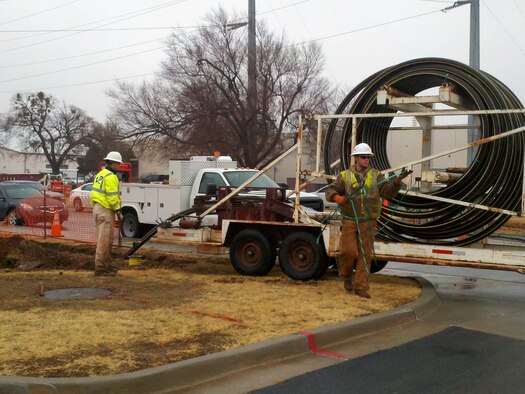 In an effort to make Tinker more energy efficient, workers install 4-inch gas lines along D Avenue. The base steam system will soon be decentralized and in its place, new energy-efficient equipment is being installed and individual gas lines are being run  to each building. (Air Force photo)