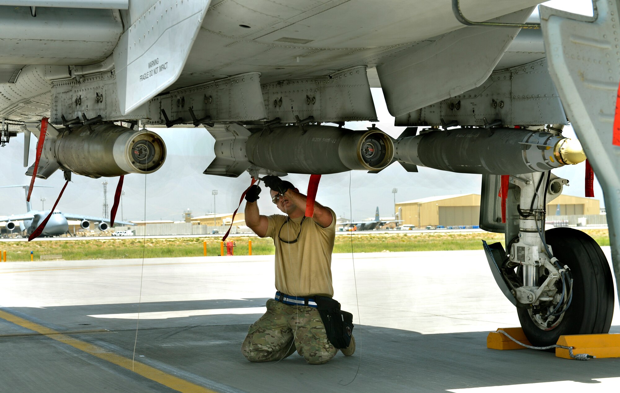 Staff Sgt. Brian Chatham, 455th Expeditionary Aircraft Maintenance Squadron weapons load crew chiefs, secures munitions to an A-10C Thunderbolt II aircraft with a flare on Bagram Airfield, Afghanistan, June 11. The Thunderbolt II can employ a wide variety of conventional munitions, including general purpose bombs, cluster bomb units, laser guided bombs, joint direct attack munitions or JDAM, wind corrected munitions dispenser or WCMD, AGM-65 Maverick and AIM-9 Sidewinder missiles, rockets, illumination flares and the GAU-8/A 30mm cannon, capable of firing 3,900 rounds per minute. (U.S. Air Force photo/ Staff Sgt. Stephenie Wade)