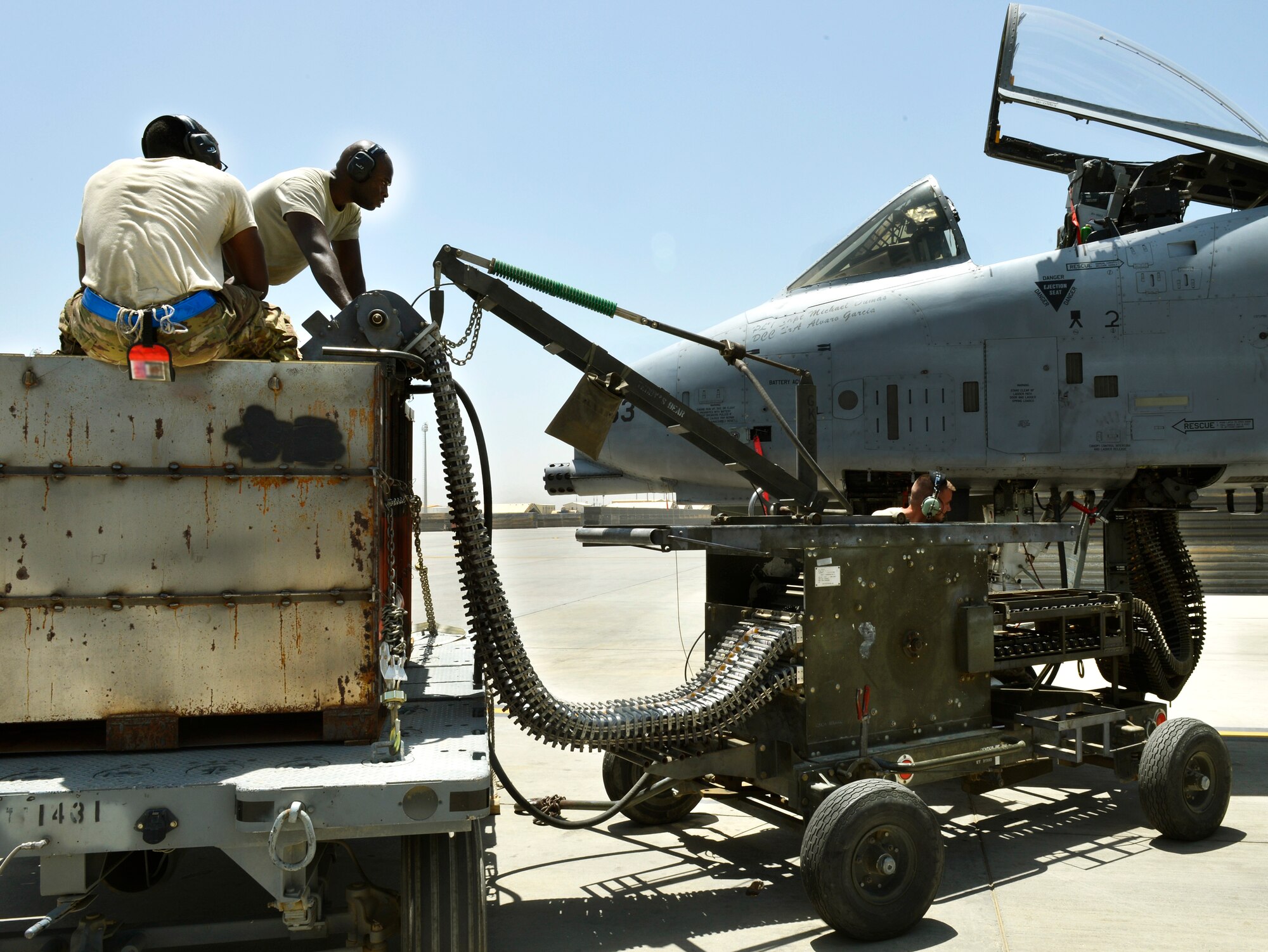 Senior Airman Tristan Franklin and Airman 1st Class Cameron Padgett, 455th Expeditionary Aircraft Maintenance Squadron weapons loaders, use an ammunition loading adaptor to feed 30-millimeter rounds into an A-10 Thunderbolt II aircraft ammo drum prior at Bagram Airfield, Afghanistan, June 11. The Airmen are deployed from Moody Air Force Base, Ga. The Thunderbolt II can employ a wide variety of conventional munitions, including general purpose bombs, cluster bomb units, laser guided bombs, joint direct attack munitions or JDAM, wind corrected munitions dispenser or WCMD, AGM-65 Maverick and AIM-9 Sidewinder missiles, rockets, illumination flares and the GAU-8/A 30mm cannon, capable of firing 3,900 rounds per minute. (U.S. Air Force photo/ Staff Sgt. Stephenie Wade)