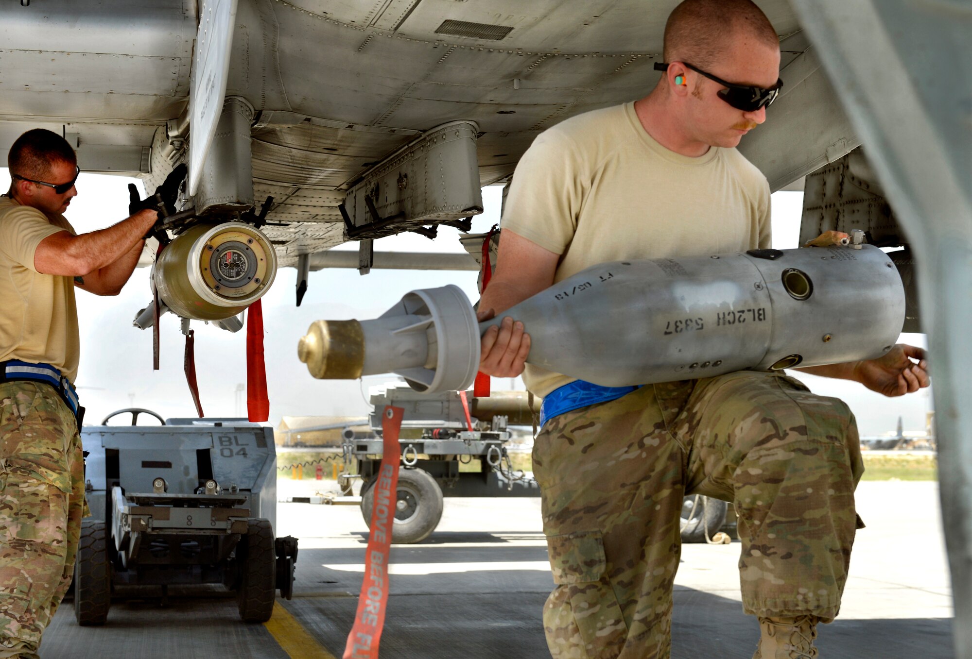 Staff Sgt. Ryan Castle and Brian Chatham, 455th Expeditionary Aircraft Maintenance Squadron weapons load crew chiefs, load precision guided munitions to an A-10C Thunderbolt II aircraft with a flare on Bagram Airfield, Afghanistan, June 11. The Thunderbolt II can employ a wide variety of conventional munitions, including general purpose bombs, cluster bomb units, laser guided bombs, joint direct attack munitions or JDAM, wind corrected munitions dispenser or WCMD, AGM-65 Maverick and AIM-9 Sidewinder missiles, rockets, illumination flares and the GAU-8/A 30mm cannon, capable of firing 3,900 rounds per minute. (U.S. Air Force photo/ Staff Sgt. Stephenie Wade)