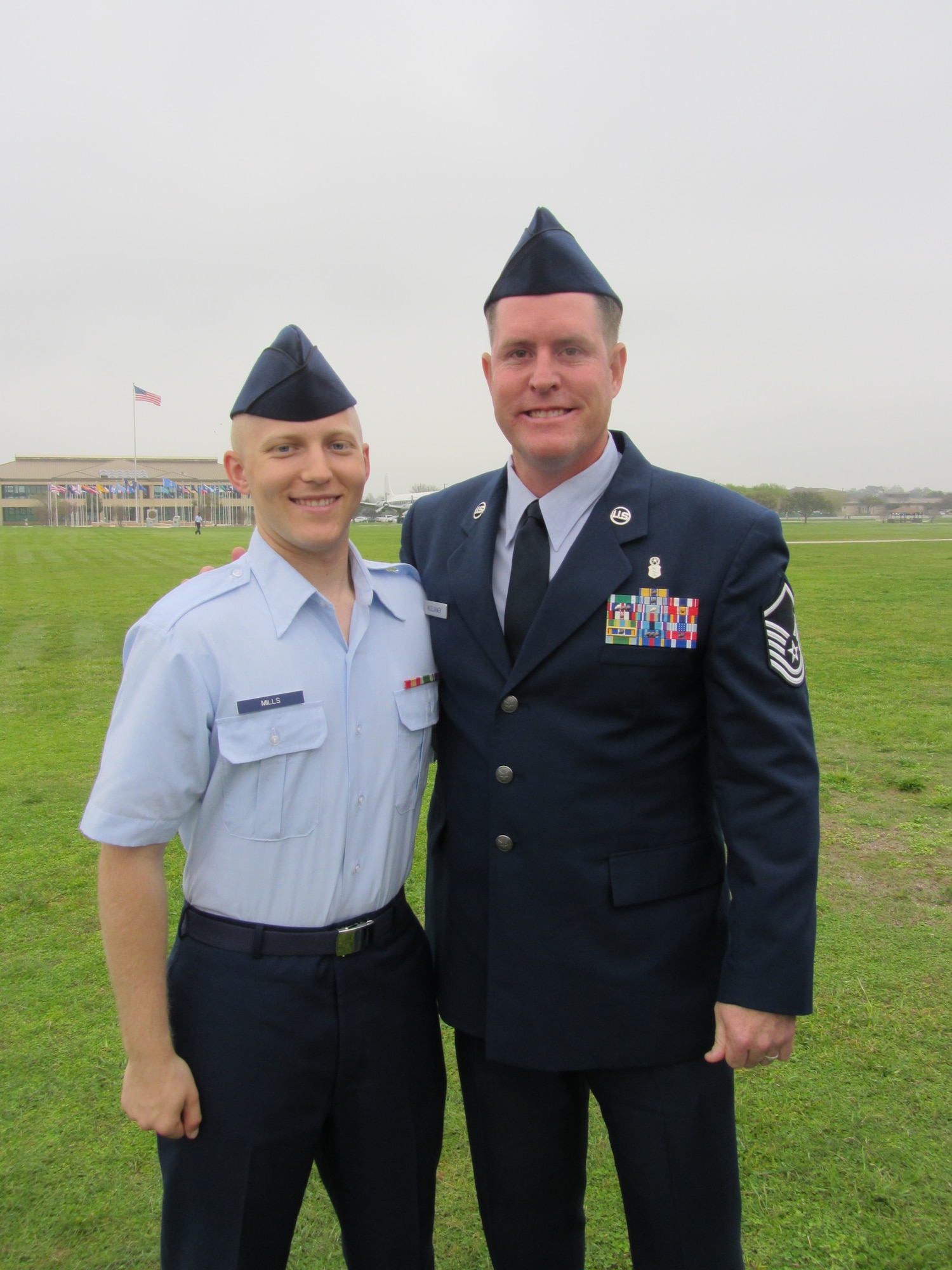 Master Sgt. Gregory McElvaney poses with his stepson Airman 1st Class Tyler Mills after his gradution from Basic Training on March 2, 2012. The two are now deployed together at Bagram Air Field, Afghanistan. McElvaney is assigned to Regional Command East Joint Theater Trauma Center and Mills is assigned to the 455th Expeditionary Security Force Squadron. (U.S. Air Force photo/ Staff Sgt. Stephenie Wade)