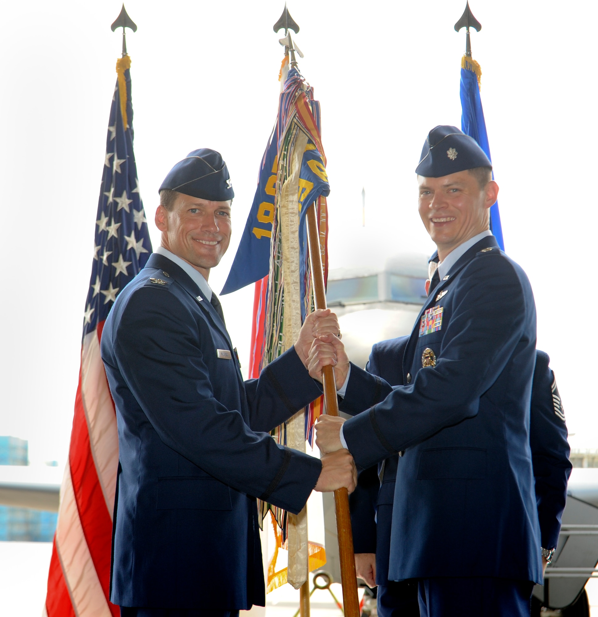U.S. Air Force Col. Peter Milohnic, 18th Operations Group commander, passes the guidon to Lt. Col. Jack Flynt III, 909th Air Refueling Squadron commander, during the 909th ARS change of command on Kadena Air Base, Japan, June 14, 2013. Flynt recently served as the Chief, Capabilities Analysis and Concepts Branch, Directorate of Force Structure, Resources and Assessment, Joint Staff, at the Pentagon in Washington, D.C. (U.S. Air Force photo by Airman 1st Class Malia Jenkins/Released) 