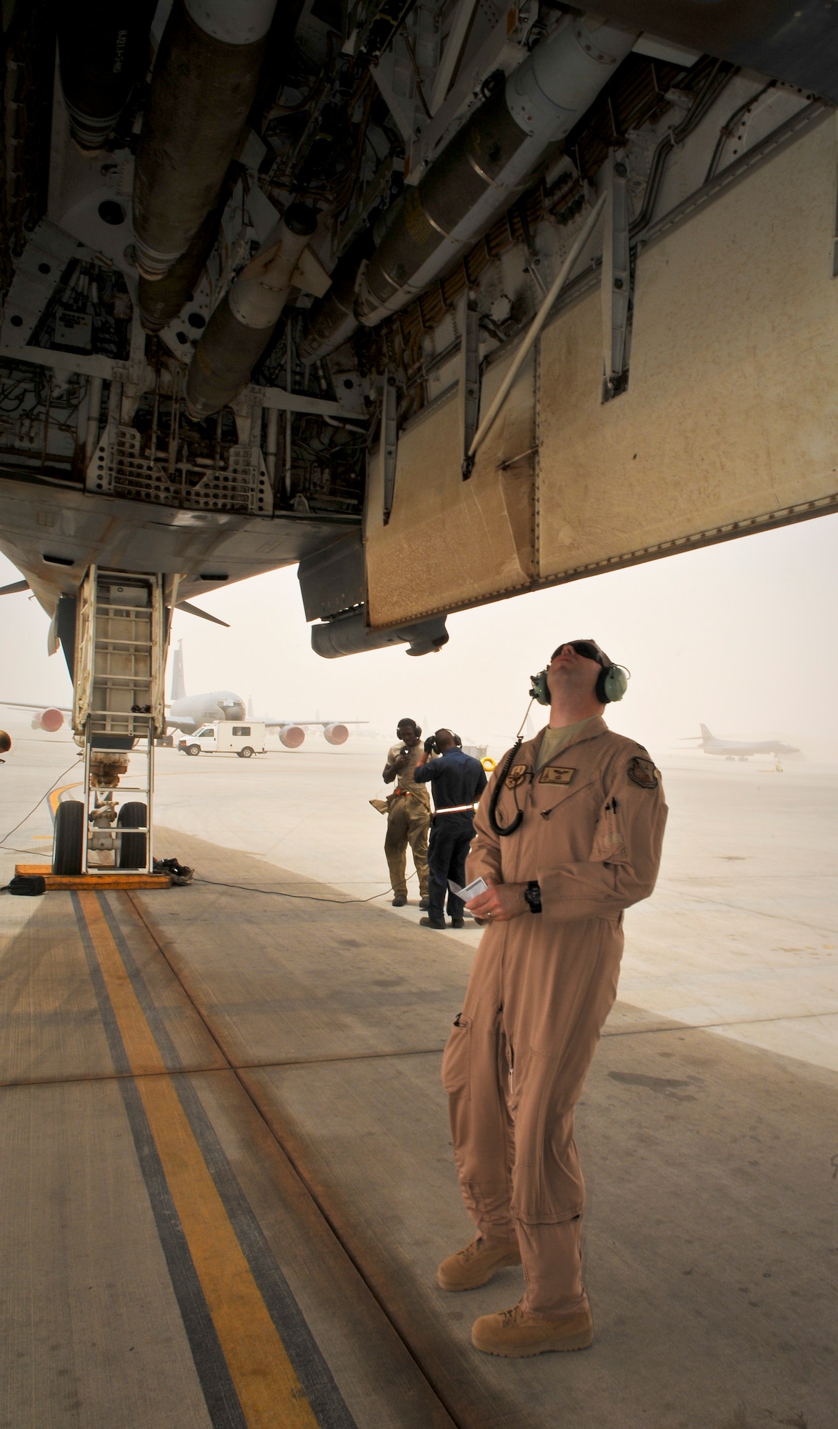 Capt. Brandon Packard performs pre-flight checks of a B-1B Lancer June 11, 2013, at the 379th Air Expeditionary Wing in Southwest Asia. Packard is a 34th Expeditionary Bomb Squadron weapons systems officer deployed from Ellsworth Air Force Base, S.D. (U.S. Air Force photo/Senior Airman Benjamin Stratton)